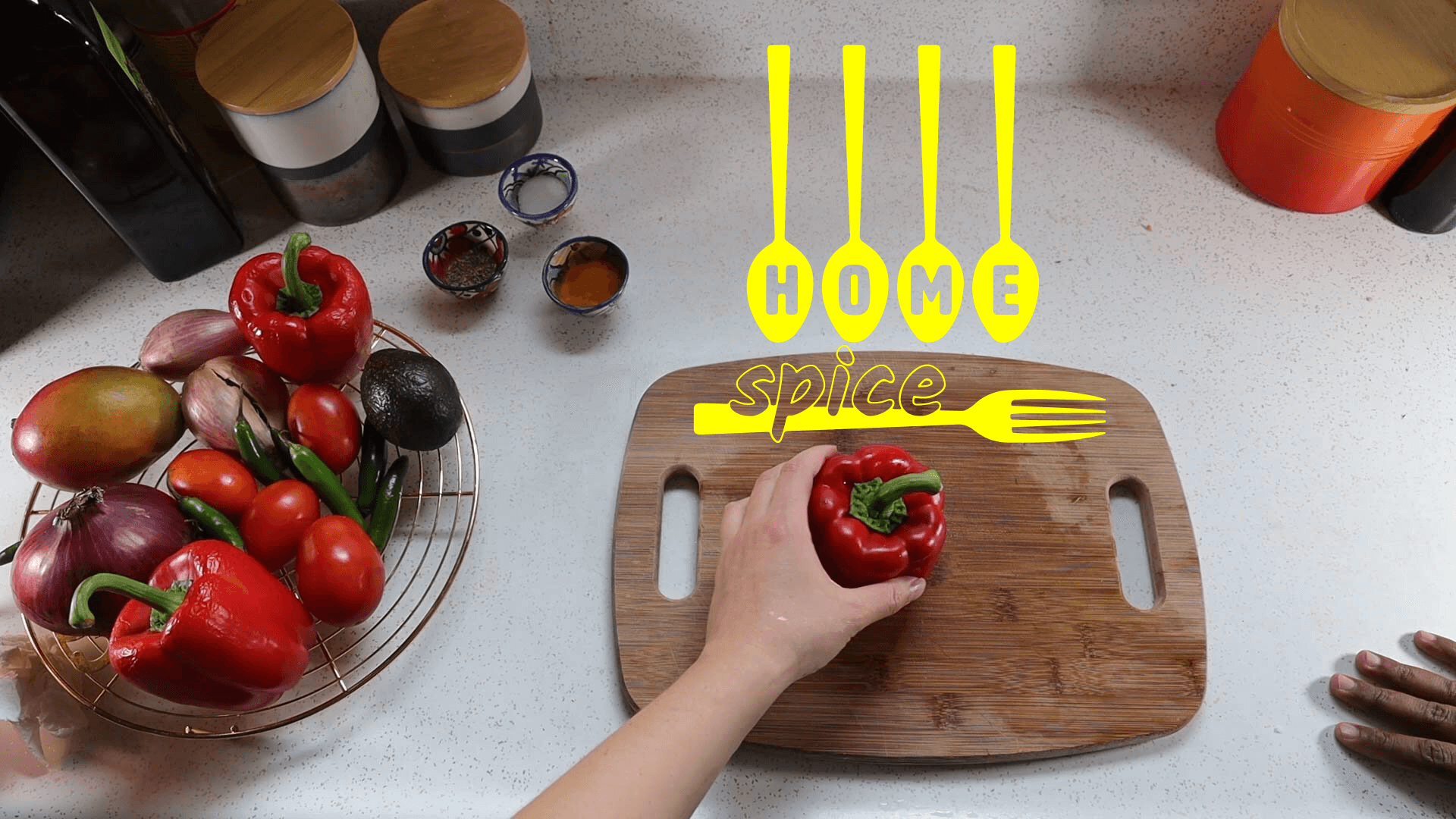 Two cooks' hands near a cutting board.