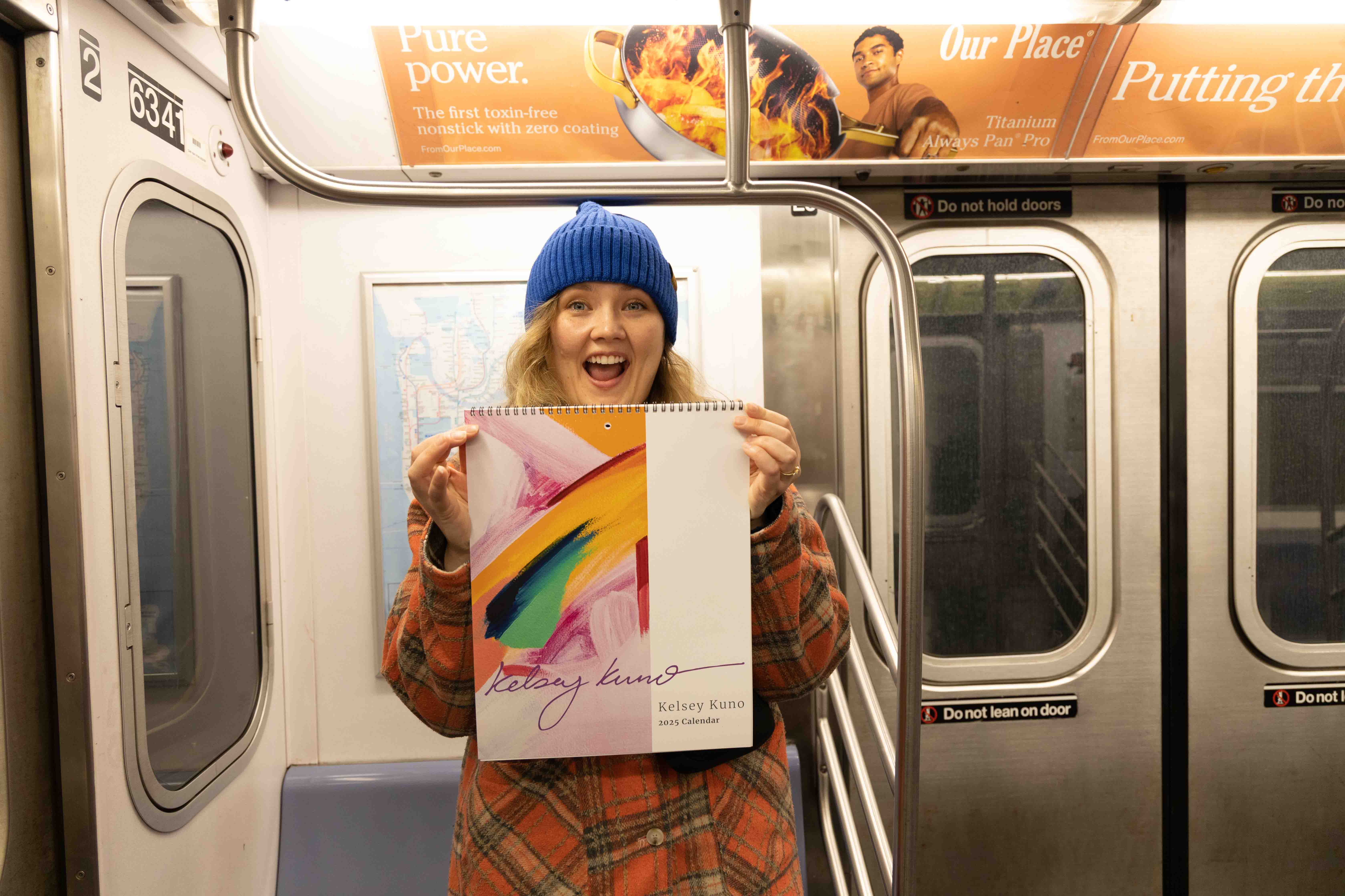 Kelsey Kuno and her promotional calendar in the NY subway